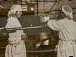 Подогретое молоко отправляется на сепарирование. Мастер А. Фанина и аппаратчик И. Соболева регулируют приток молока на сепаратор, добиваясь 30% жирности. Завод «Молочное2, 1955
